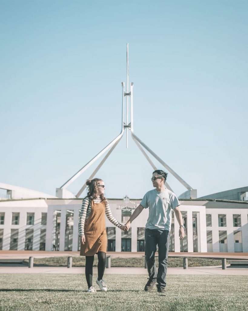 Canberra Parliament House External Couple Strolling Hand in Hand